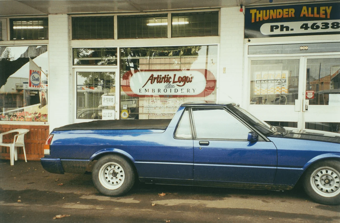The early Artistic Logos & Embroidery shopfront with a ute parked out front