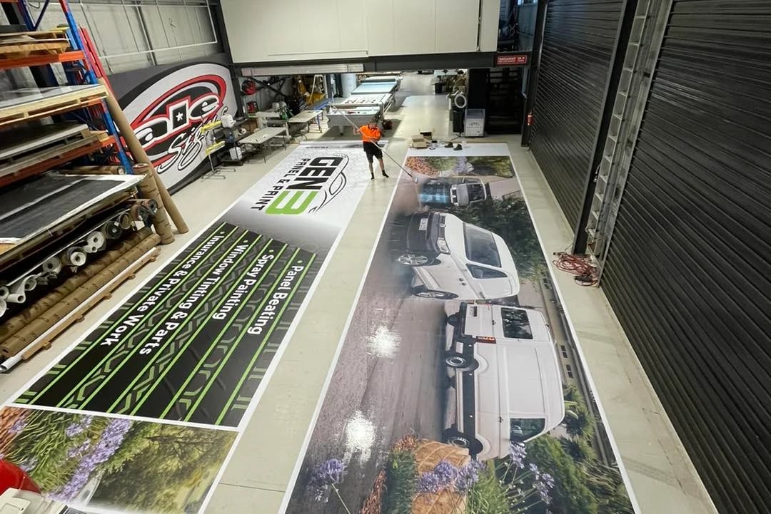 Large banner printed and laid out on the workshop floor