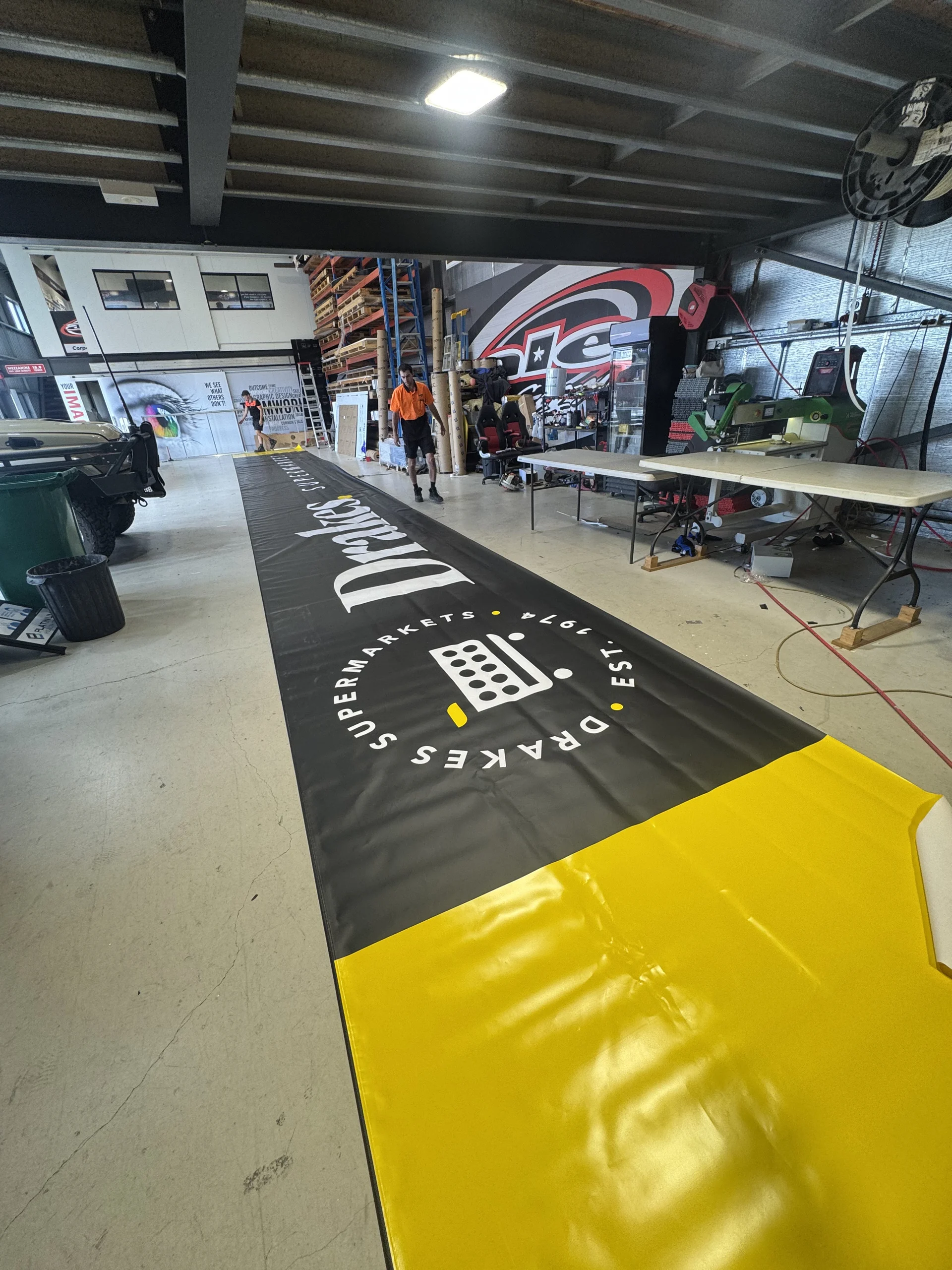 Long Drakes Supermarkets banner rolled out in the ALE workshop