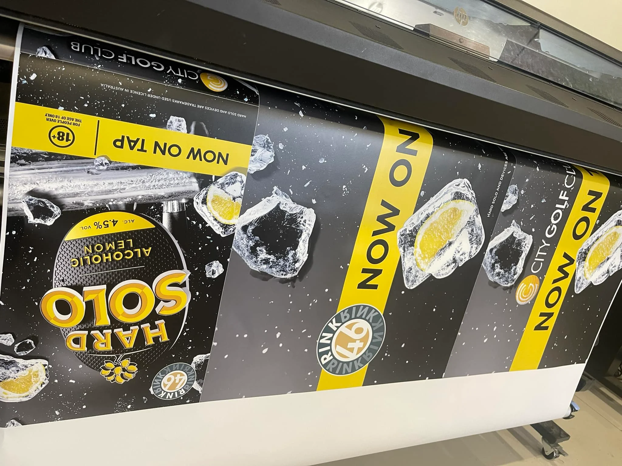 Large-format promotional posters coming off the printer
