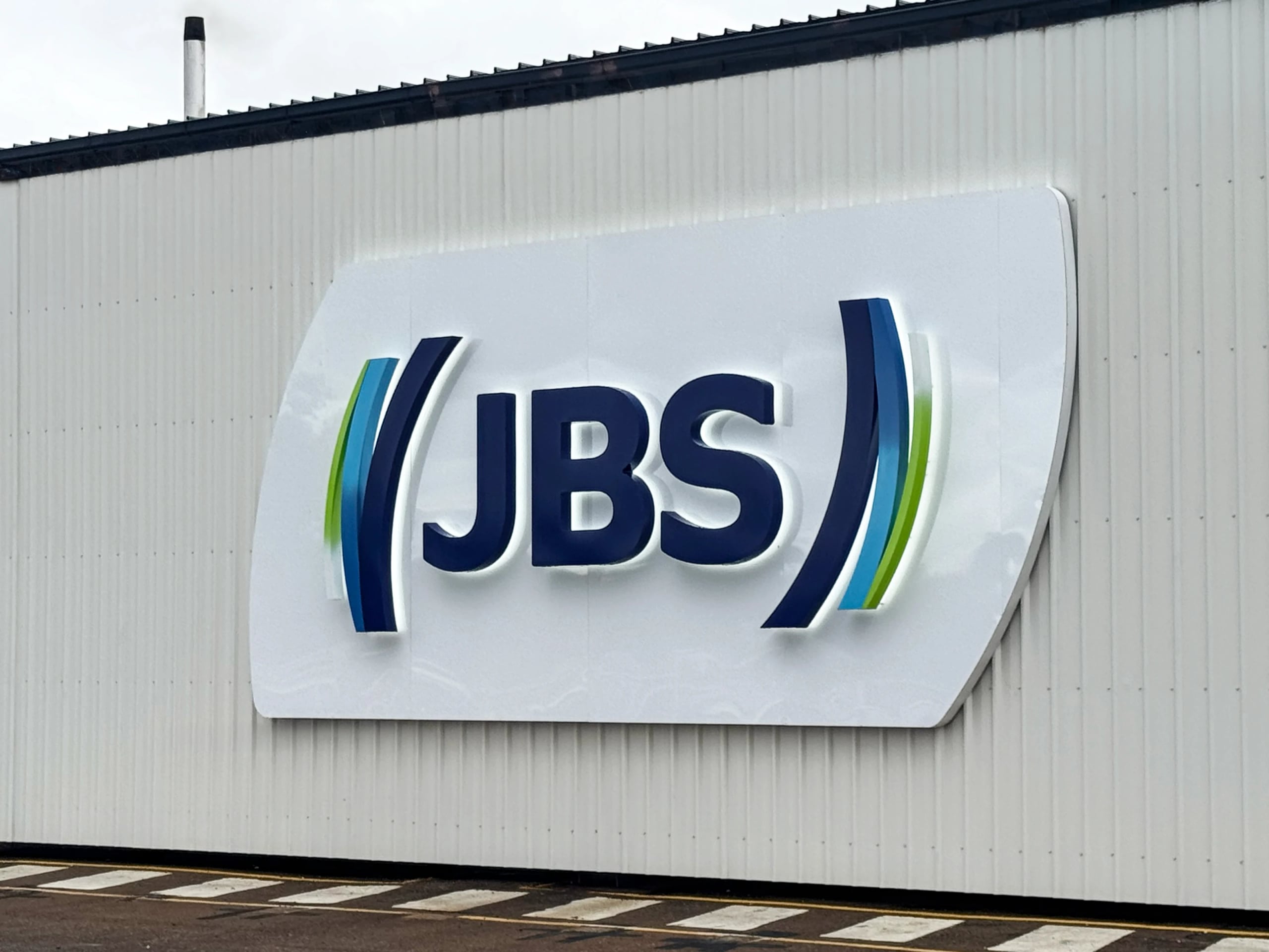 Illuminated JBS sign on the wall at JBS Townsville QLD