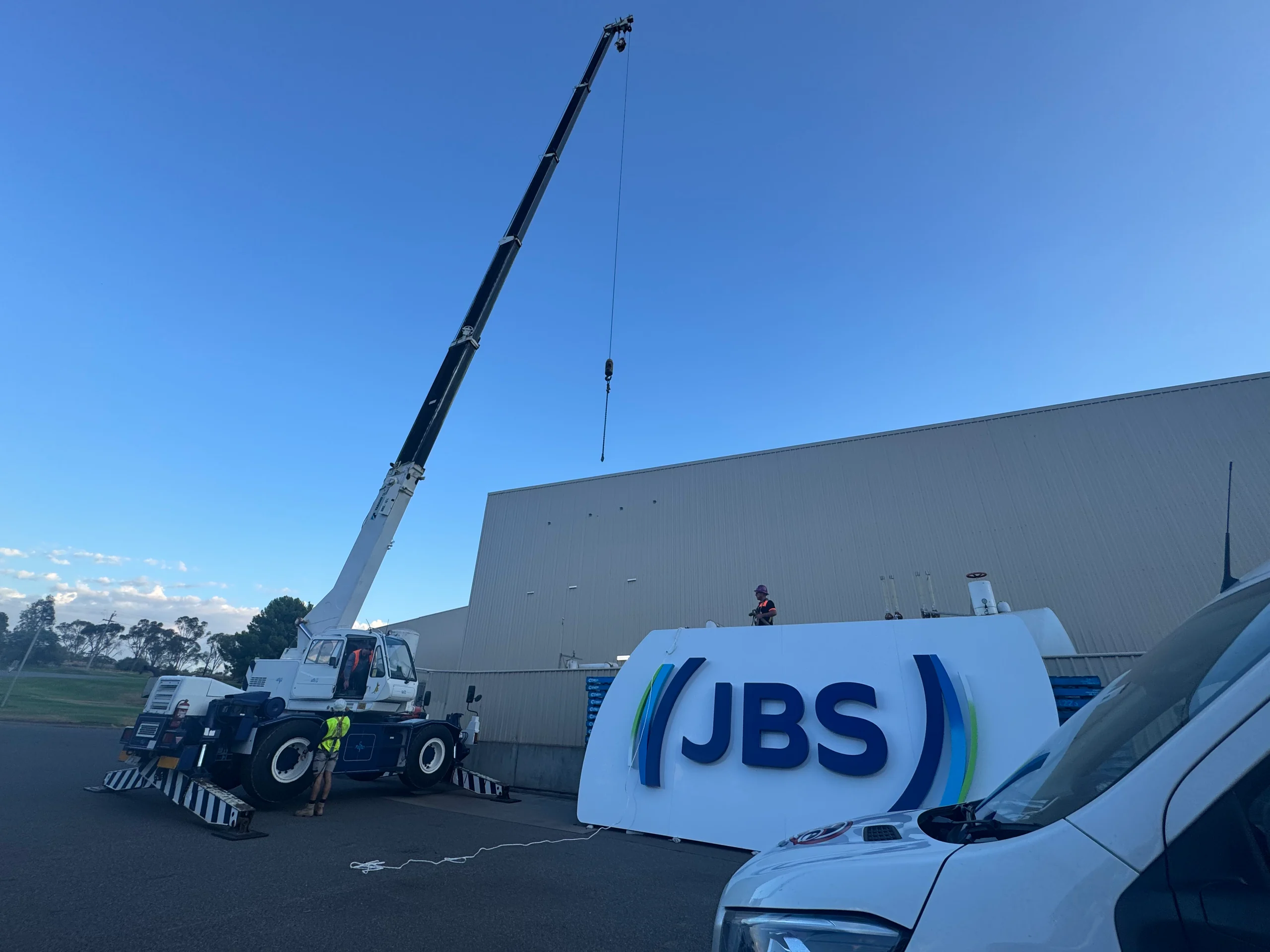 Crane lifting the JBS sign into place at JBS Riverina, Yanco NSW