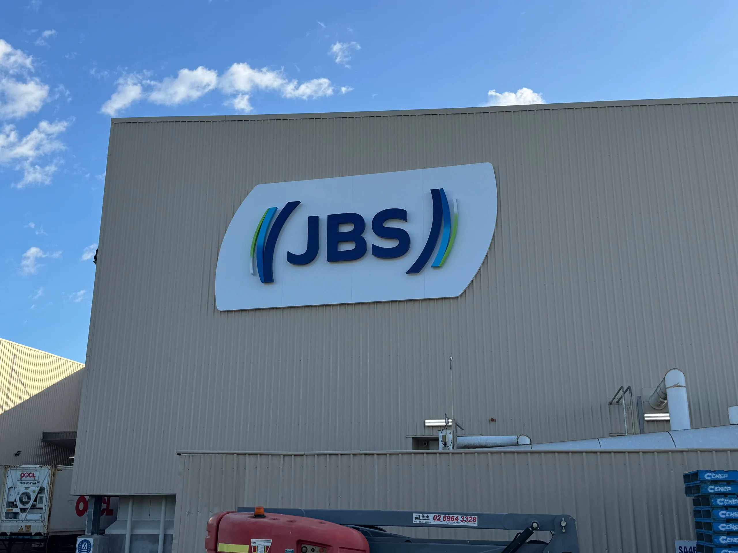 Illuminated JBS building sign on the wall at JBS Riverina, Yanco NSW