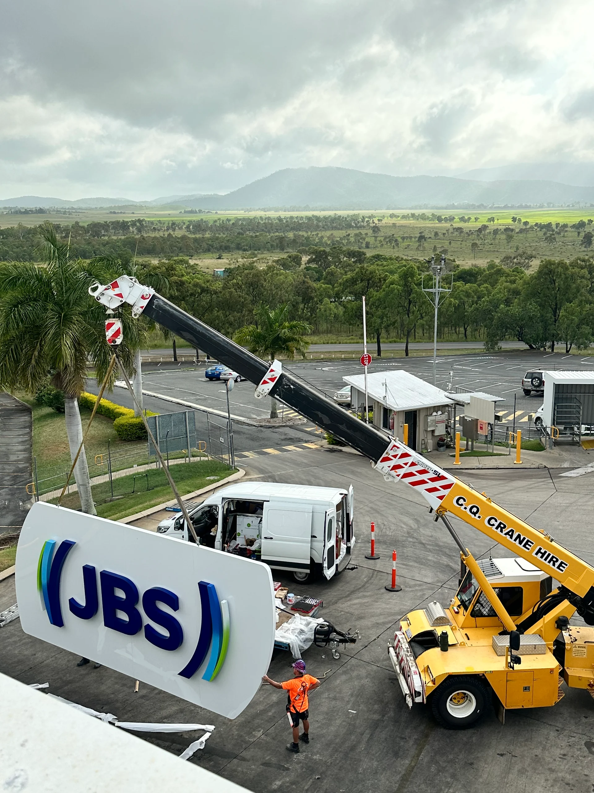 Crane lifting a JBS sign at JBS Rockhampton QLD