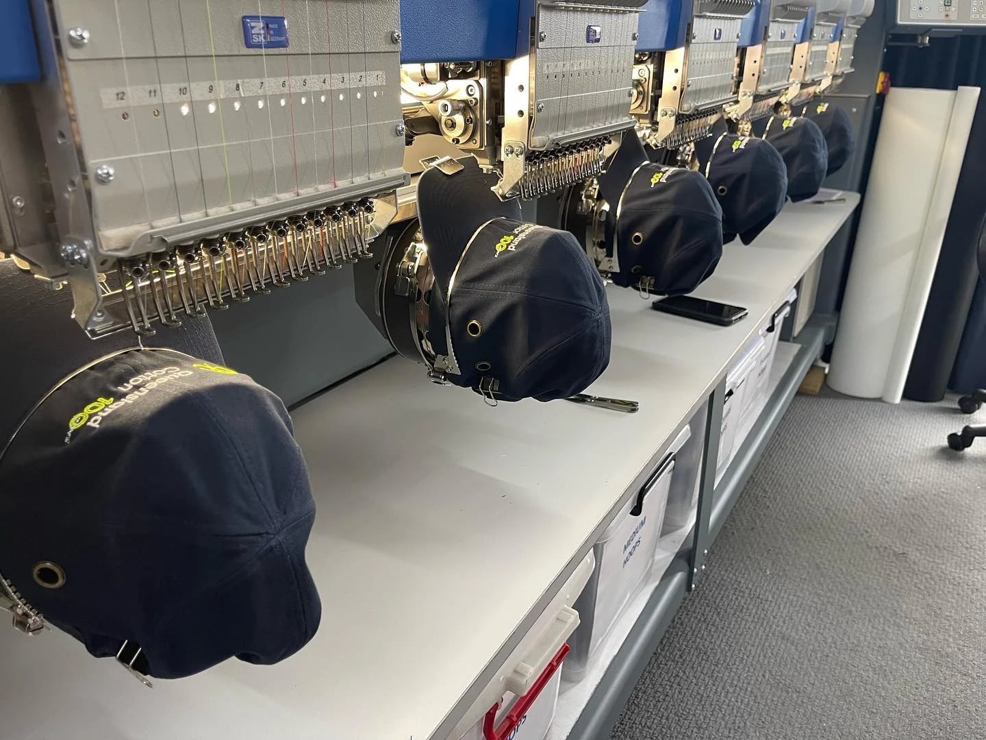 Caps lined up for embroidery on an ALE machine