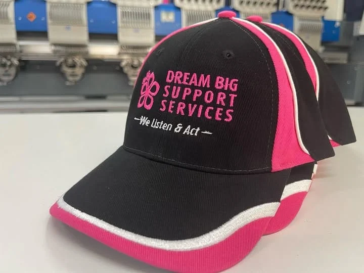 Dream Big Support Services branded caps