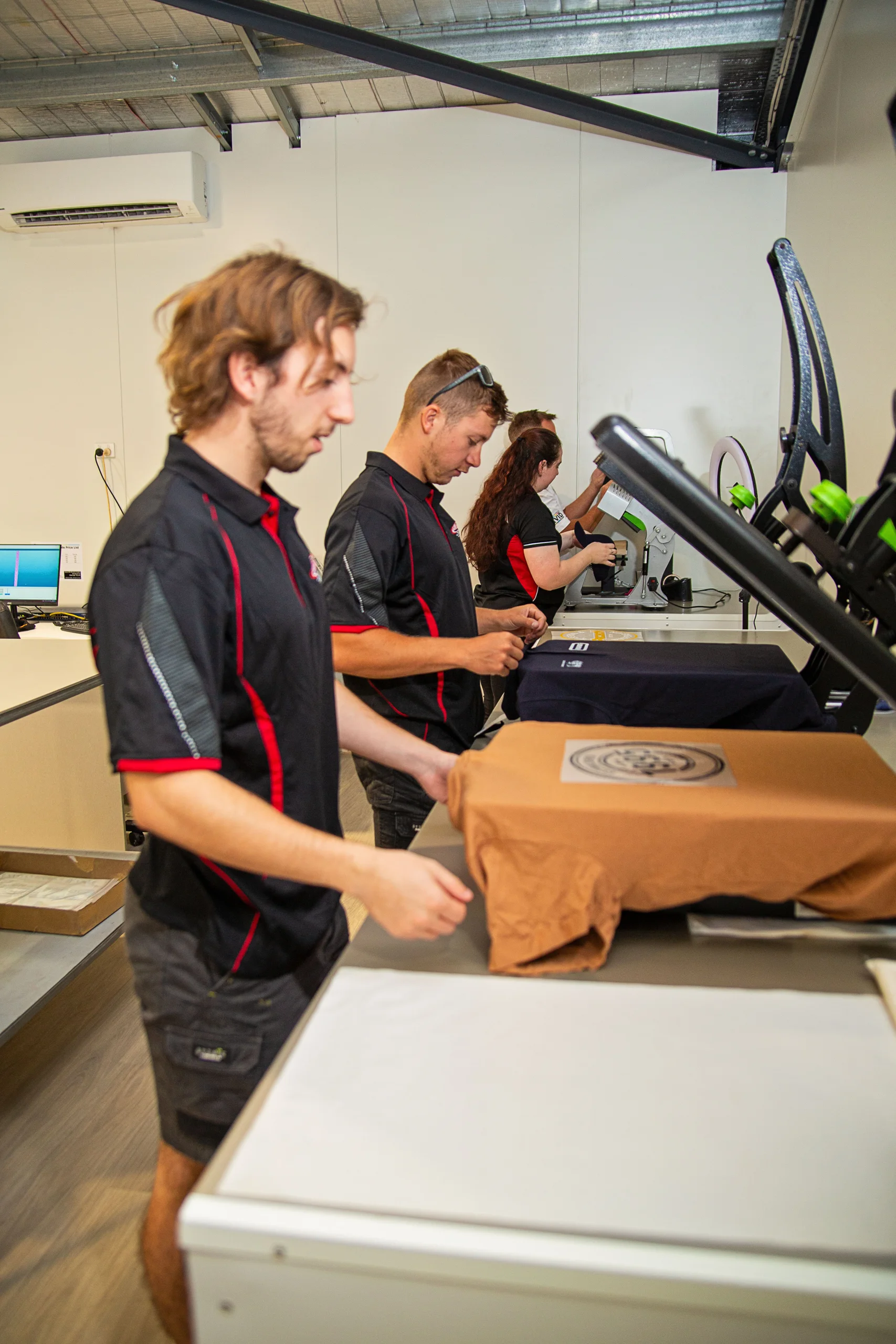 ALE team pressing Vivid Colour prints onto shirts