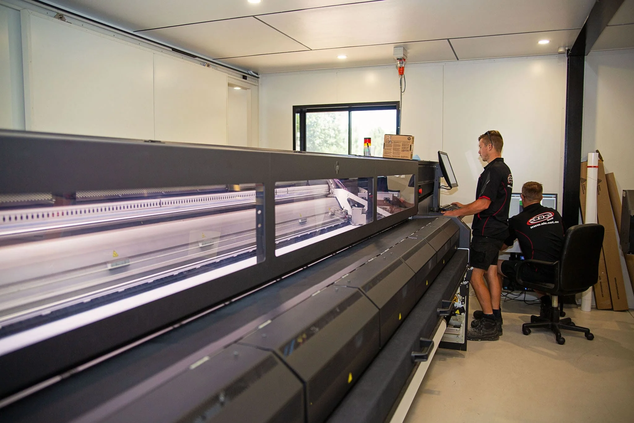 ALE team member at the 3.2 metre HP Latex printer
