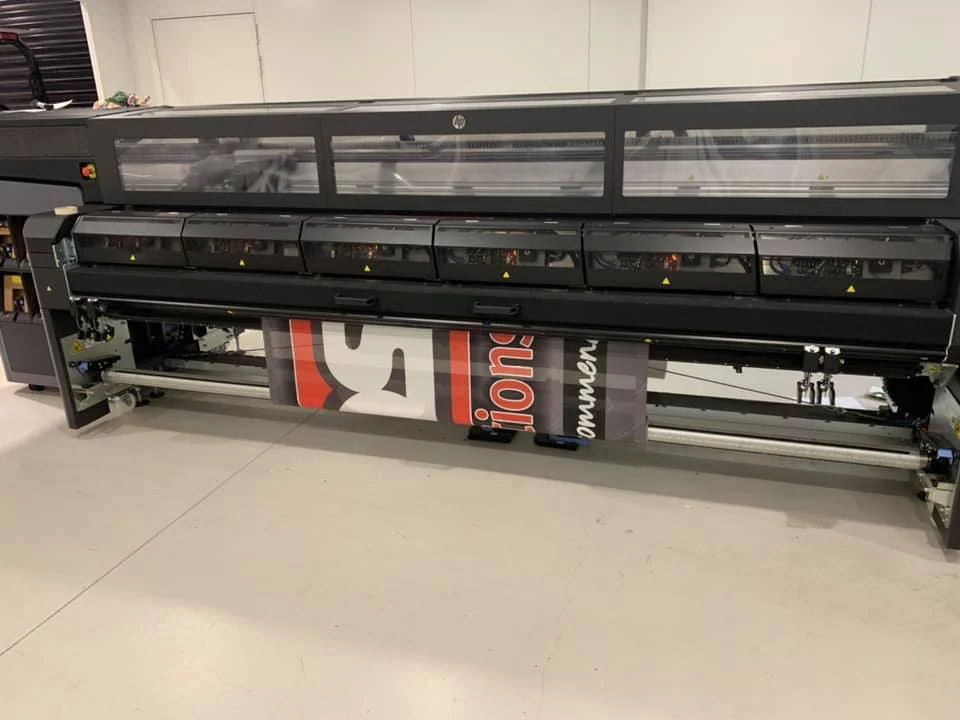 Wide-format printer running a fence mesh print